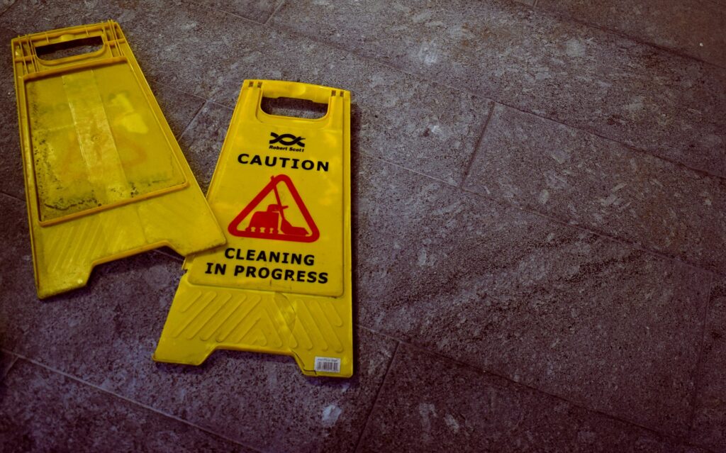 Caution sign broken in half on the floor